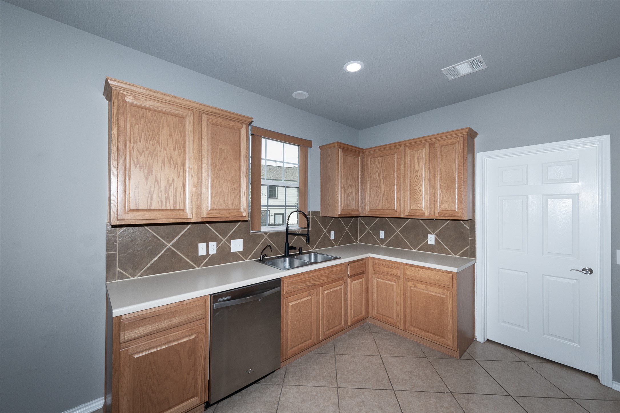 184 Tulip Cove Kyle, TX 78640 - Photo 10 of 40 a kitchen with a sink and cabinets