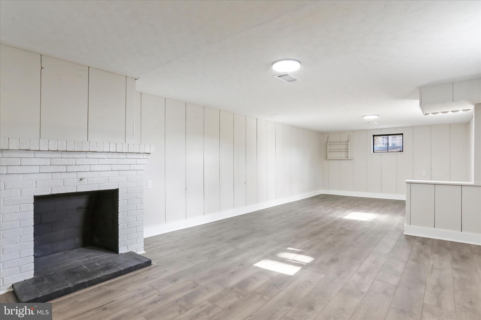 10 Linden Boulevard Middletown, MD 21769 - Photo 19 of 28 a view of empty room with wooden floor and fireplace
