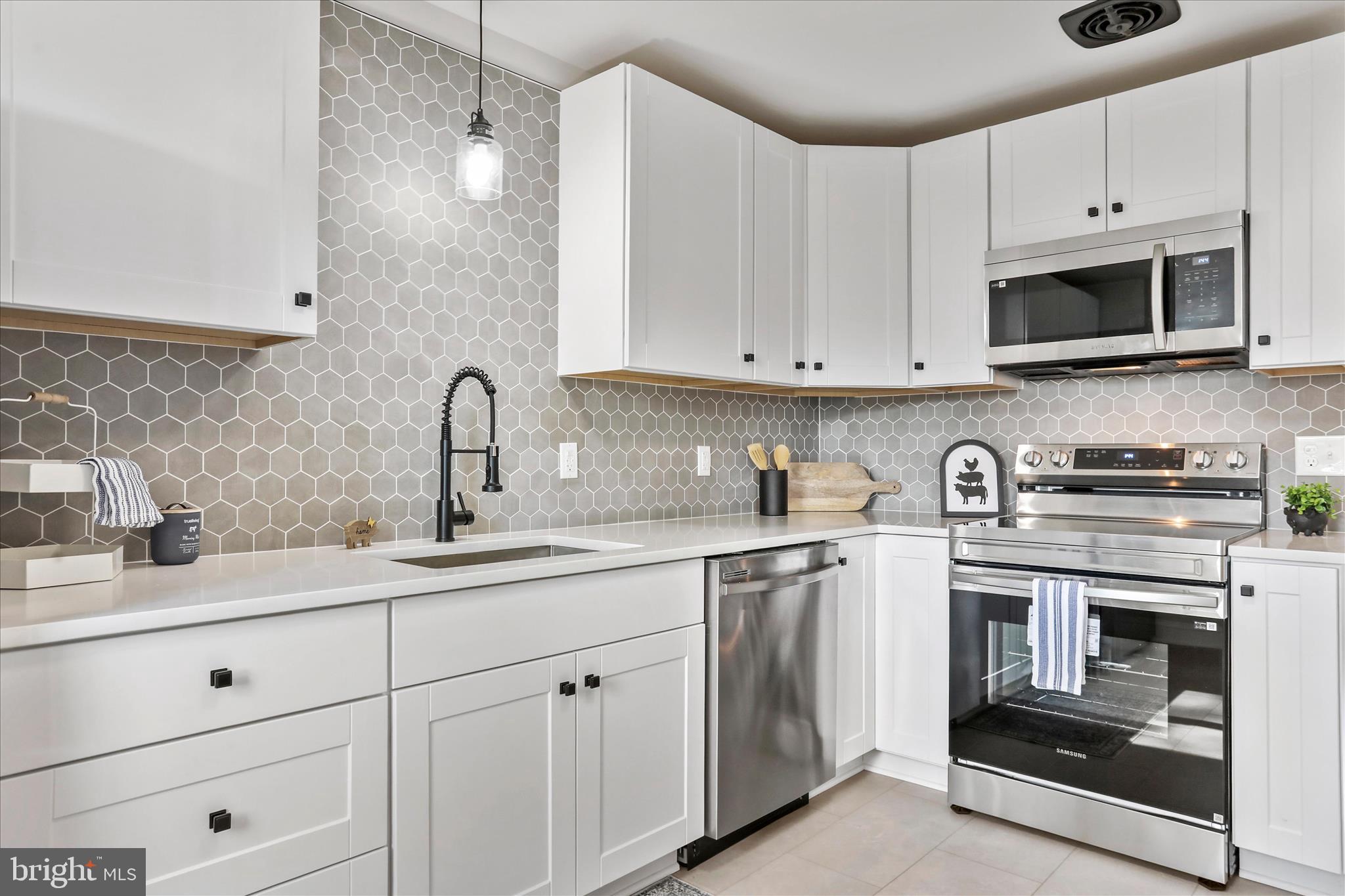 10 Linden Boulevard Middletown, MD 21769 - Photo 7 of 28 a kitchen with white cabinets stainless steel appliances and sink