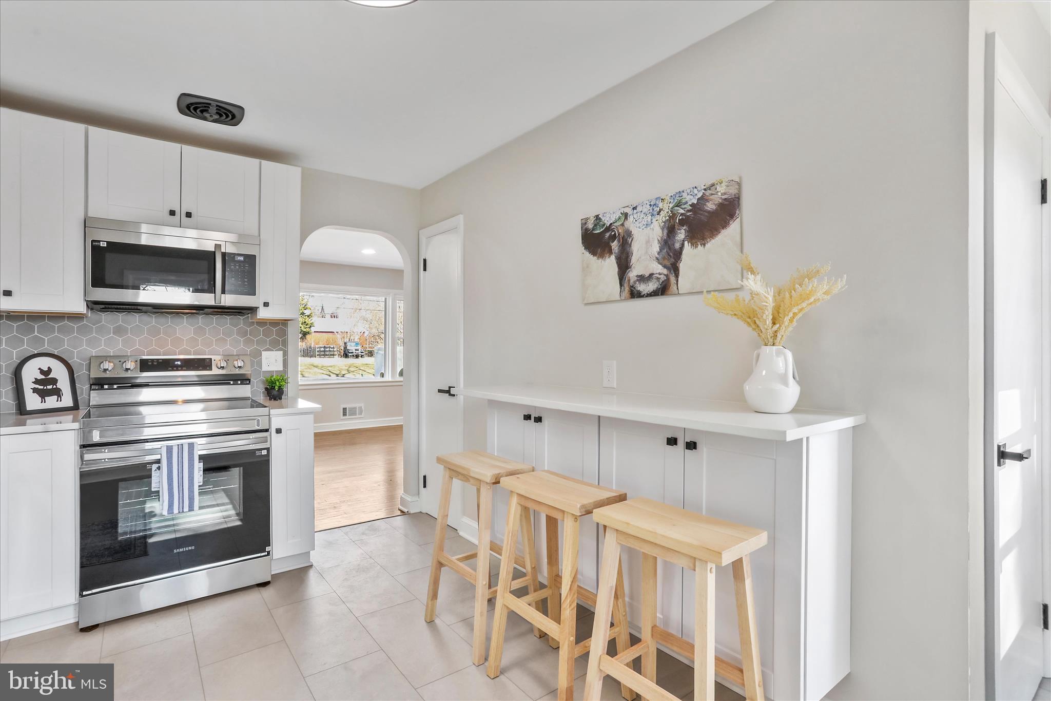 10 Linden Boulevard Middletown, MD 21769 - Photo 8 of 28 a kitchen with stainless steel appliances a stove microwave and cabinets