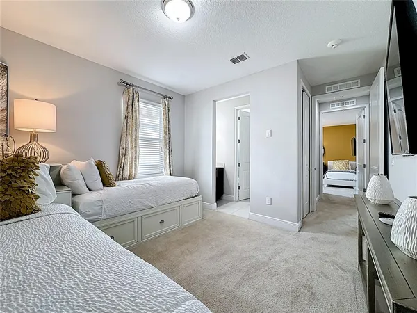 a spacious bathroom with a granite countertop sink a large mirror and a bathtub