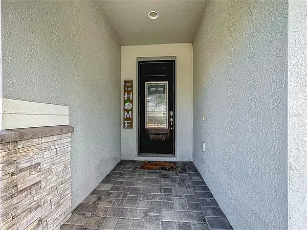 a room with stainless steel appliances kitchen island granite countertop a sink and cabinets