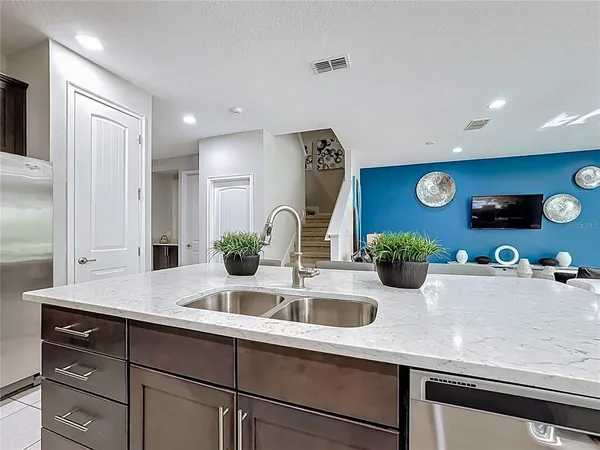 a kitchen with stainless steel appliances granite countertop a refrigerator and a stove top oven