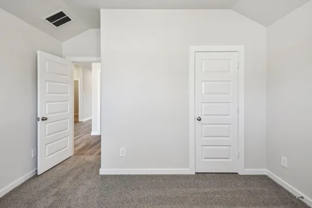 an empty room with closet area
