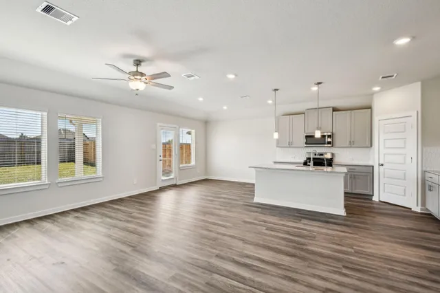 a view of kitchen with granite countertop cabinets stainless steel appliances and a large window
