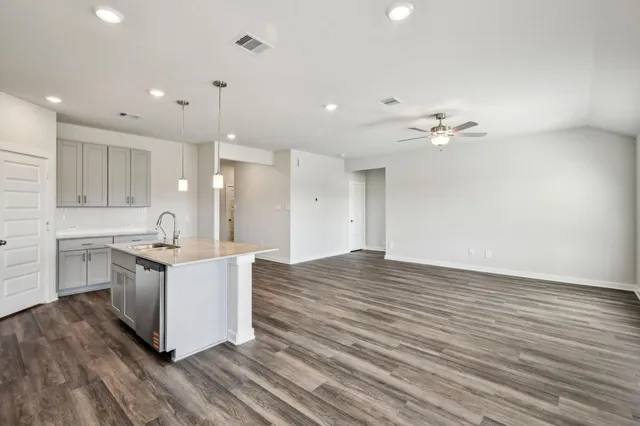 a kitchen with granite countertop a stove and a sink