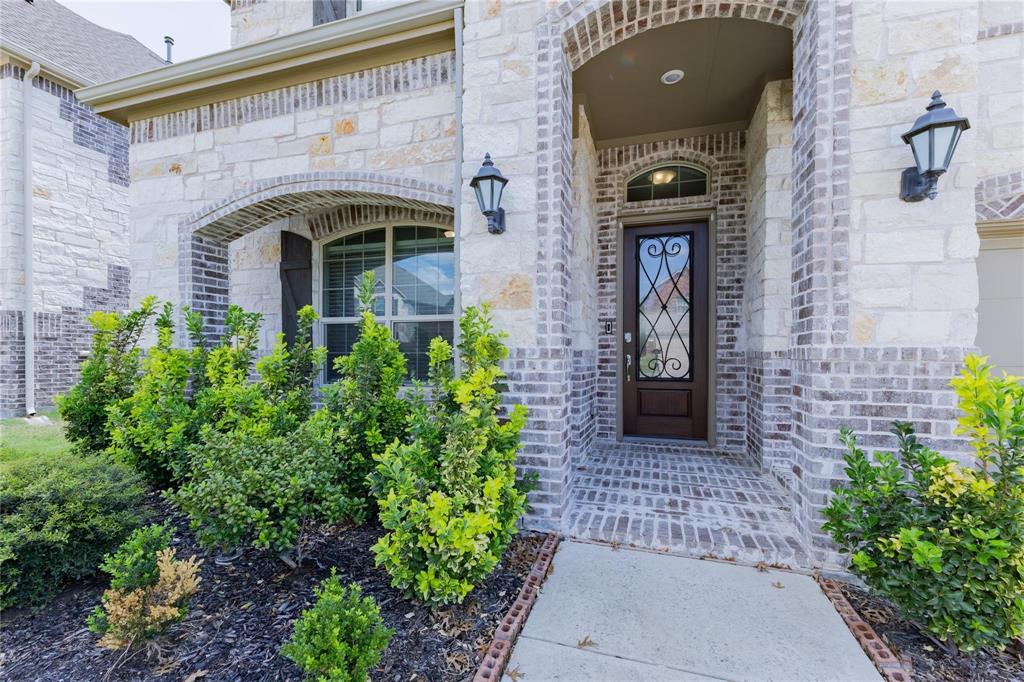 3920 Bentgrass Road Plano, TX 75023 - Photo 3 of 30 a front view of a house with a garden