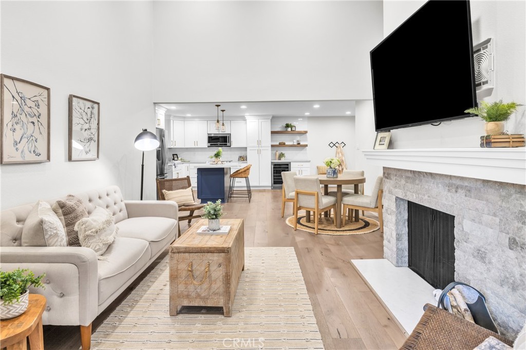 7890 East Spring Street, Unit 10F Long Beach, CA 90815 - Photo 11 of 31 a living room with furniture a fireplace and a flat screen tv