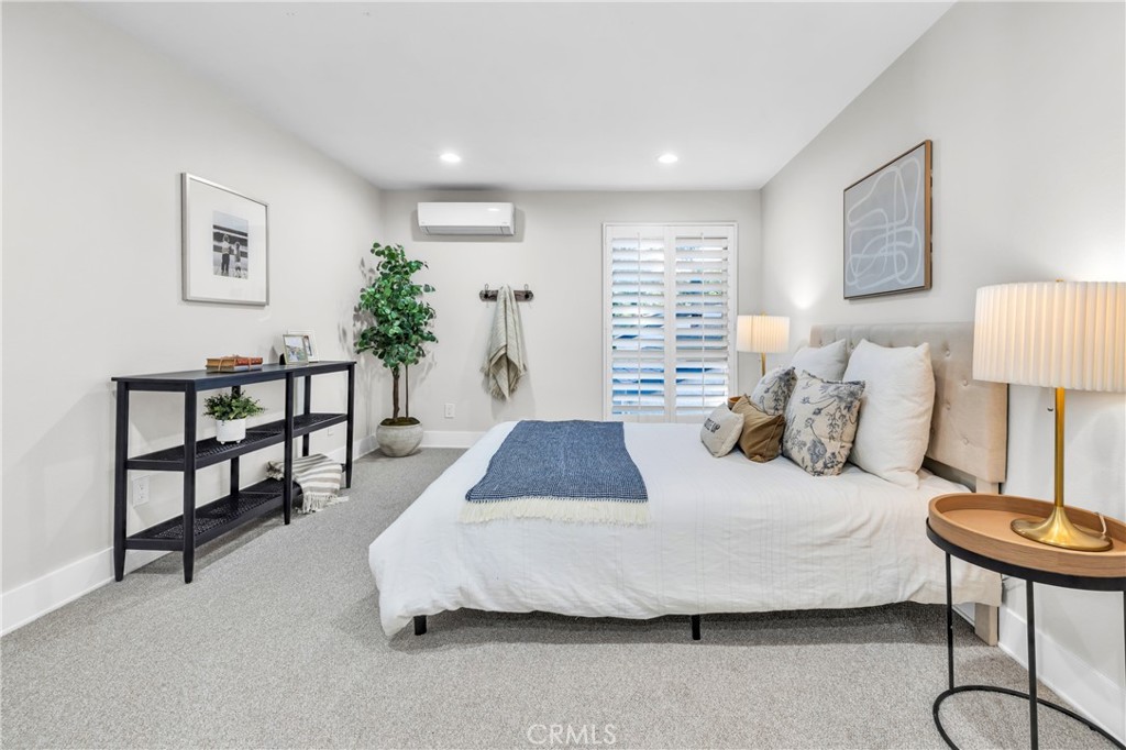 7890 East Spring Street, Unit 10F Long Beach, CA 90815 - Photo 15 of 31 a bedroom with a bed lamps and window