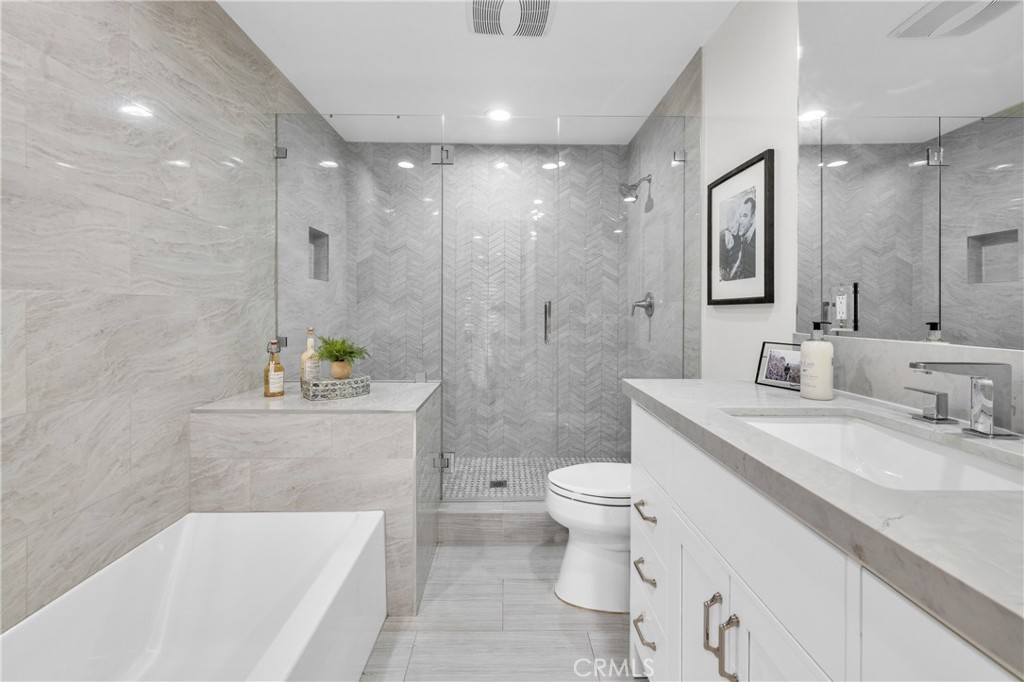 7890 East Spring Street, Unit 10F Long Beach, CA 90815 - Photo 17 of 31 a bathroom with a sink a toilet and shower
