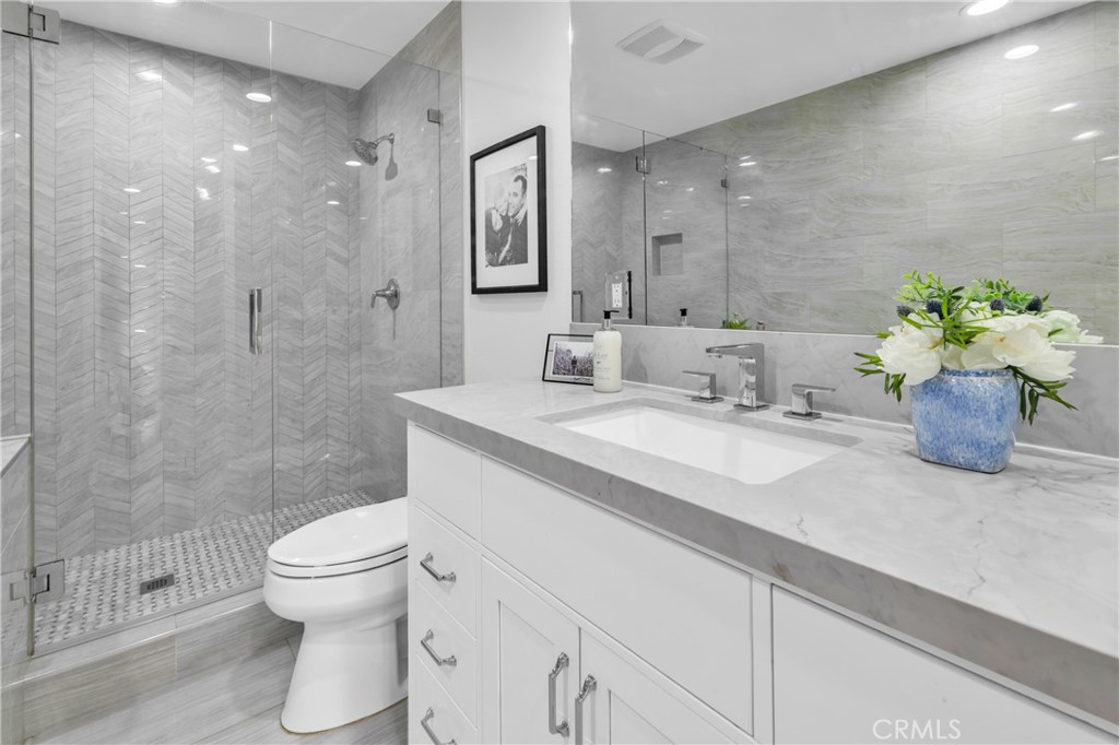 7890 East Spring Street, Unit 10F Long Beach, CA 90815 - Photo 18 of 31 a bathroom with a sink toilet and shower