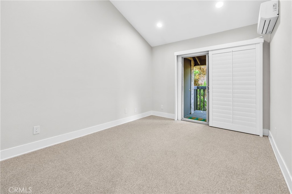 7890 East Spring Street, Unit 10F Long Beach, CA 90815 - Photo 21 of 31 an empty room with windows and closet