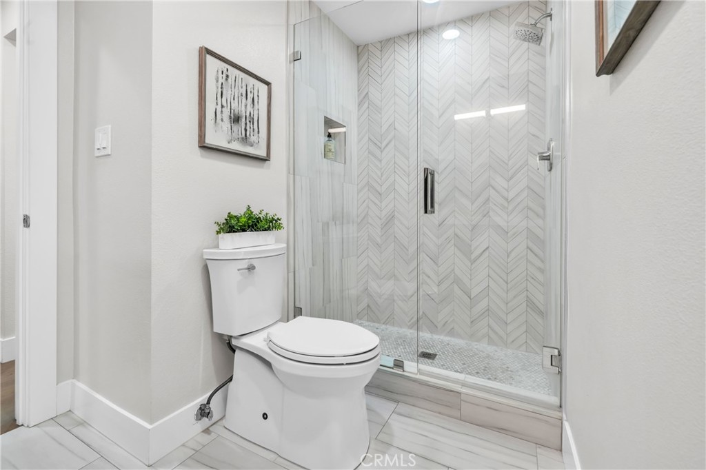 7890 East Spring Street, Unit 10F Long Beach, CA 90815 - Photo 23 of 31 a bathroom with a toilet and a shower