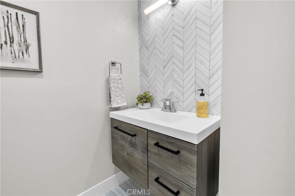 7890 East Spring Street, Unit 10F Long Beach, CA 90815 - Photo 24 of 31 a bathroom with a sink and a mirror