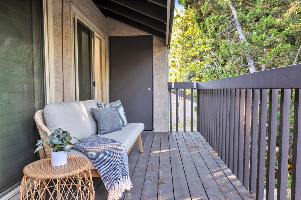 7890 East Spring Street, Unit 10F Long Beach, CA 90815 - Photo 28 of 31 a balcony with furniture and a potted plant