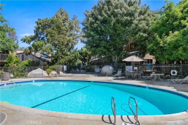 a view of a house with pool and chairs