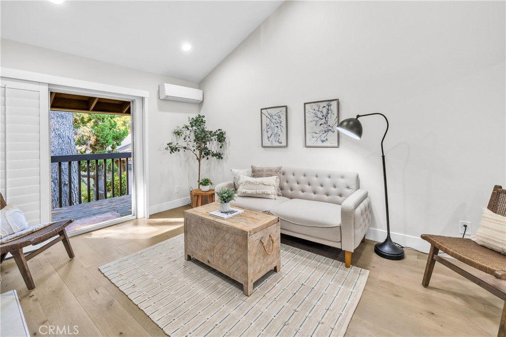7890 East Spring Street, Unit 10F Long Beach, CA 90815 - Photo 9 of 31 a living room with furniture and a large window