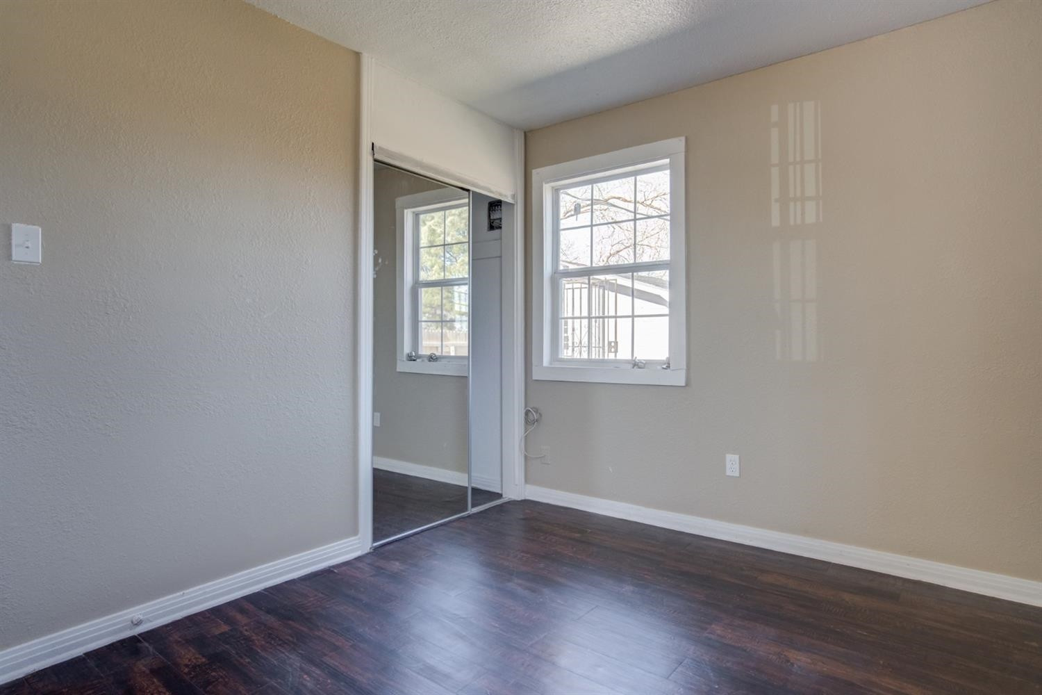 526 53rd Street Lubbock, TX 79404 - Photo 12 of 28 an empty room with wooden floor and windows