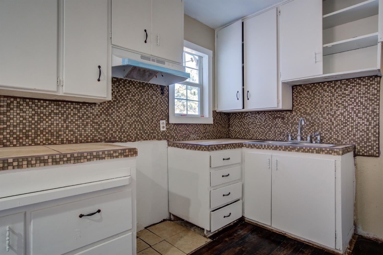 526 53rd Street Lubbock, TX 79404 - Photo 13 of 28 a kitchen with granite countertop white cabinets and white appliances