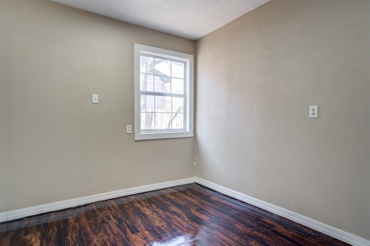 526 53rd Street Lubbock, TX 79404 - Photo 14 of 28 an empty room with wooden floor and windows