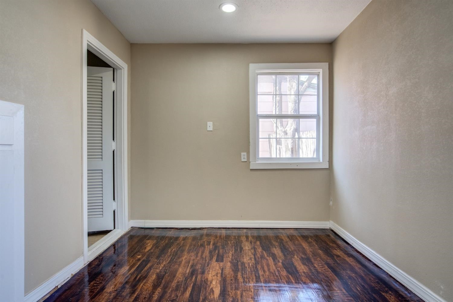 526 53rd Street Lubbock, TX 79404 - Photo 15 of 28 a view of an empty room with wooden floor and a window