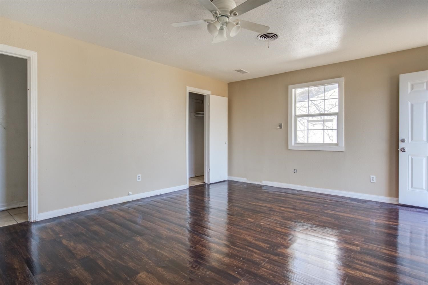 526 53rd Street Lubbock, TX 79404 - Photo 18 of 28 an empty room with wooden floor and windows