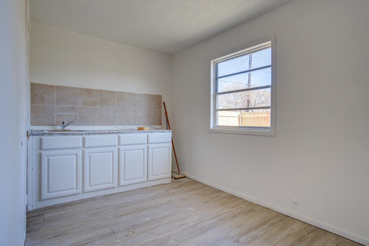 526 53rd Street Lubbock, TX 79404 - Photo 23 of 28 an empty room with wooden floor and cabinet