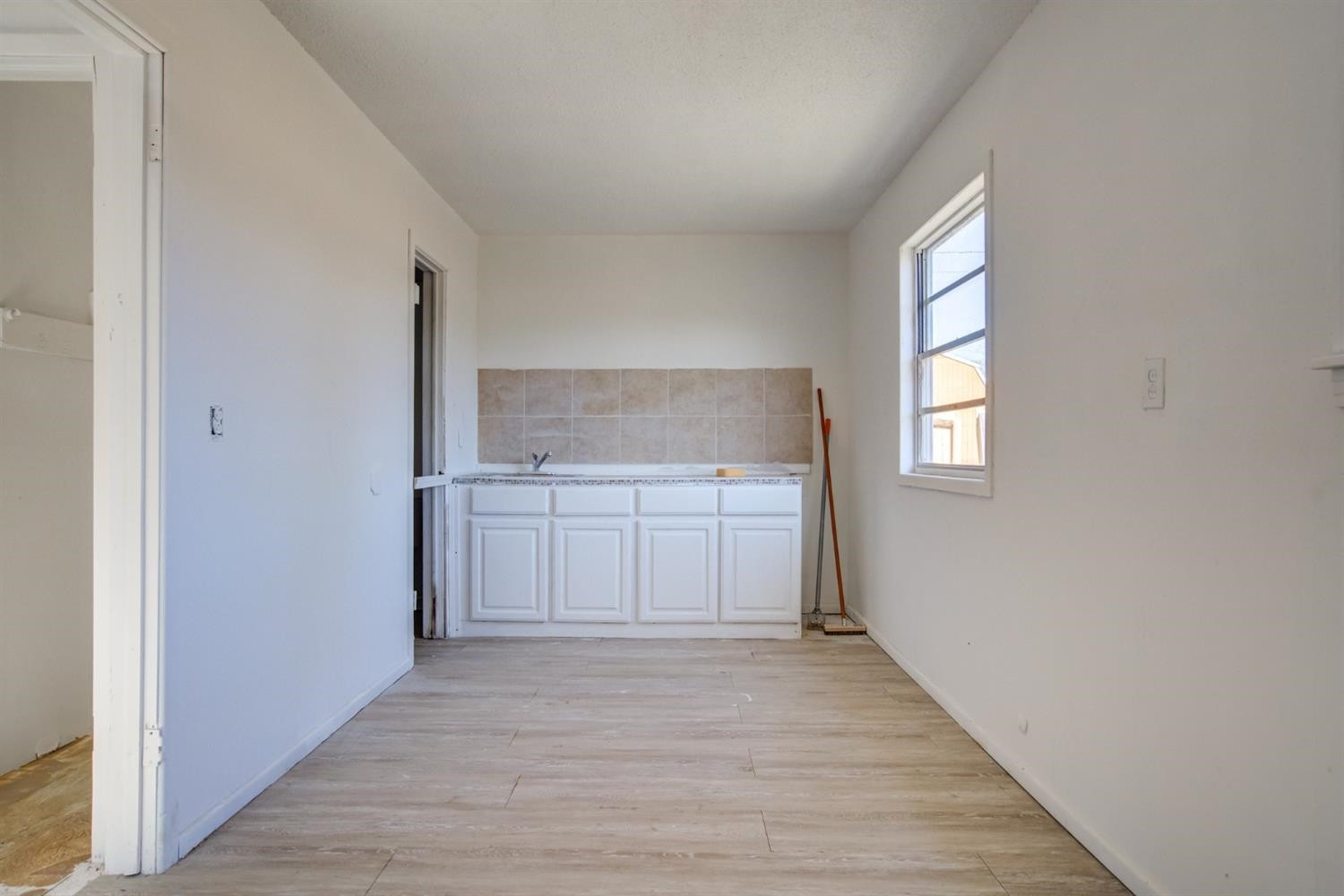 526 53rd Street Lubbock, TX 79404 - Photo 24 of 28 a view of a kitchen with a sink and dishwasher with wooden floor