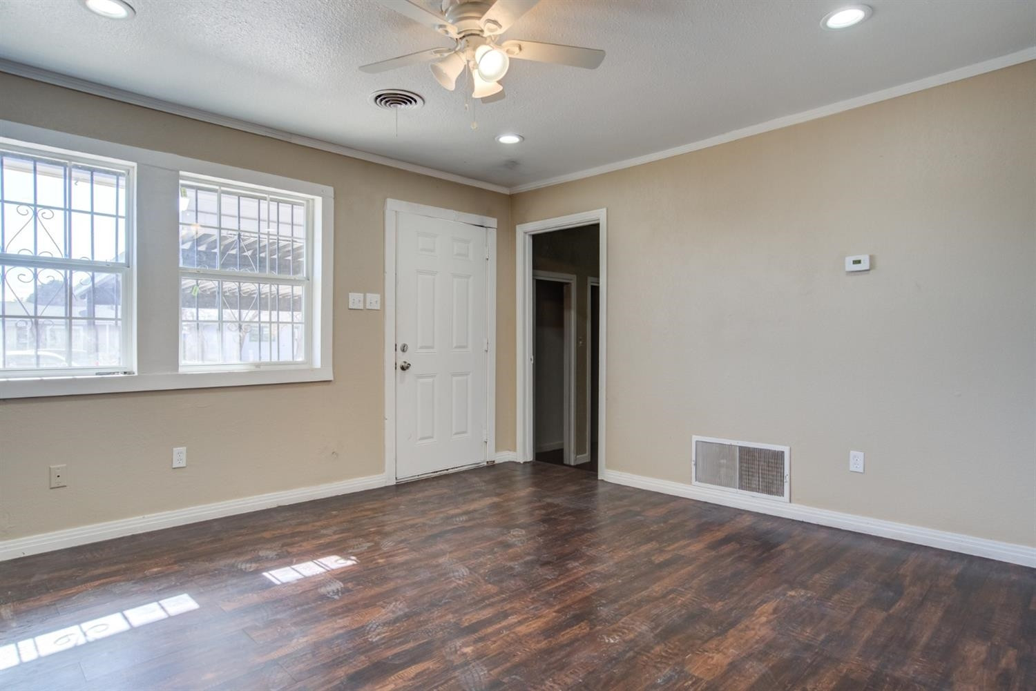 526 53rd Street Lubbock, TX 79404 - Photo 5 of 28 wooden floor in an empty room with a window