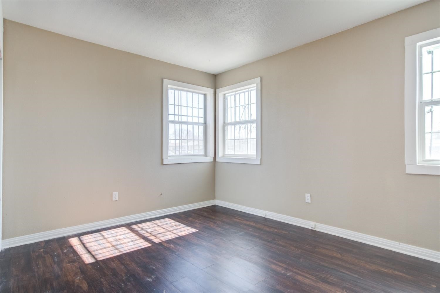 526 53rd Street Lubbock, TX 79404 - Photo 8 of 28 an empty room with wooden floor and windows