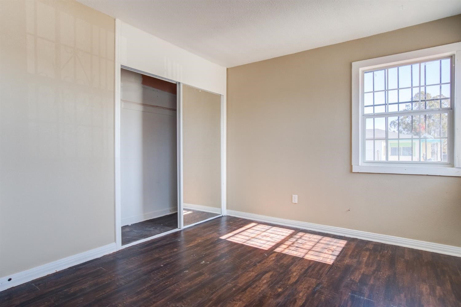 526 53rd Street Lubbock, TX 79404 - Photo 9 of 28 an empty room with wooden floor and windows