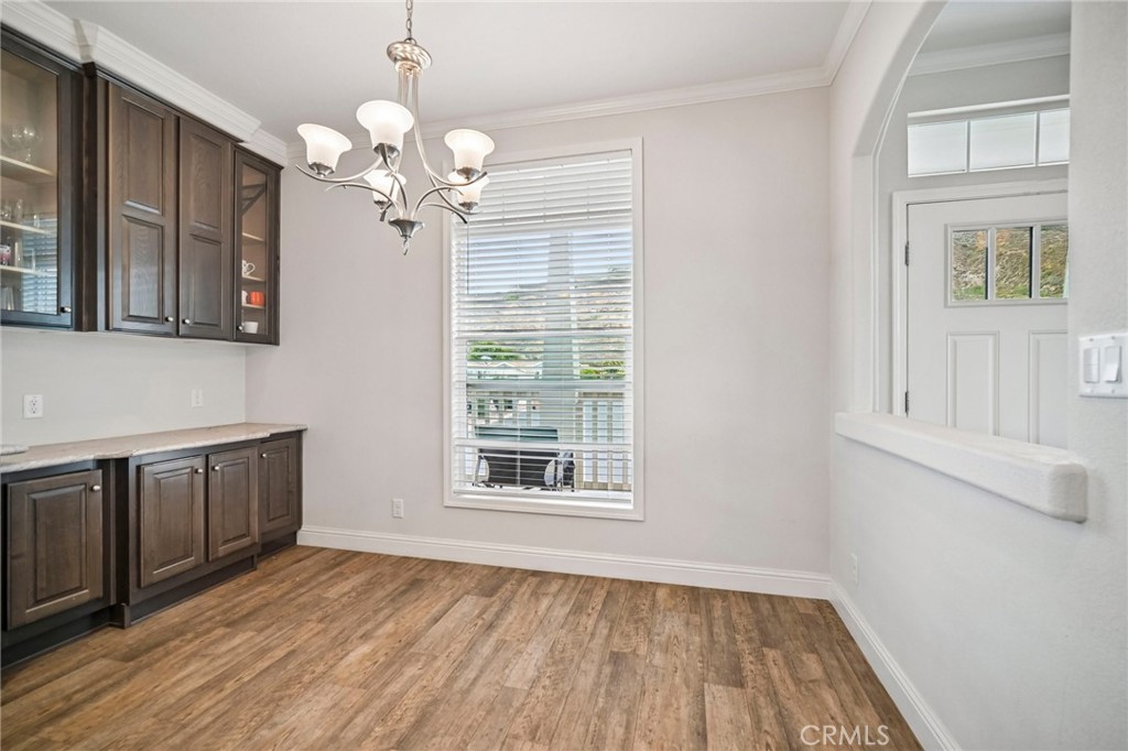 250 East Telegraph Road, Unit 307 Fillmore, CA 93015 - Photo 10 of 36 a view of an empty room with wooden floor and a window