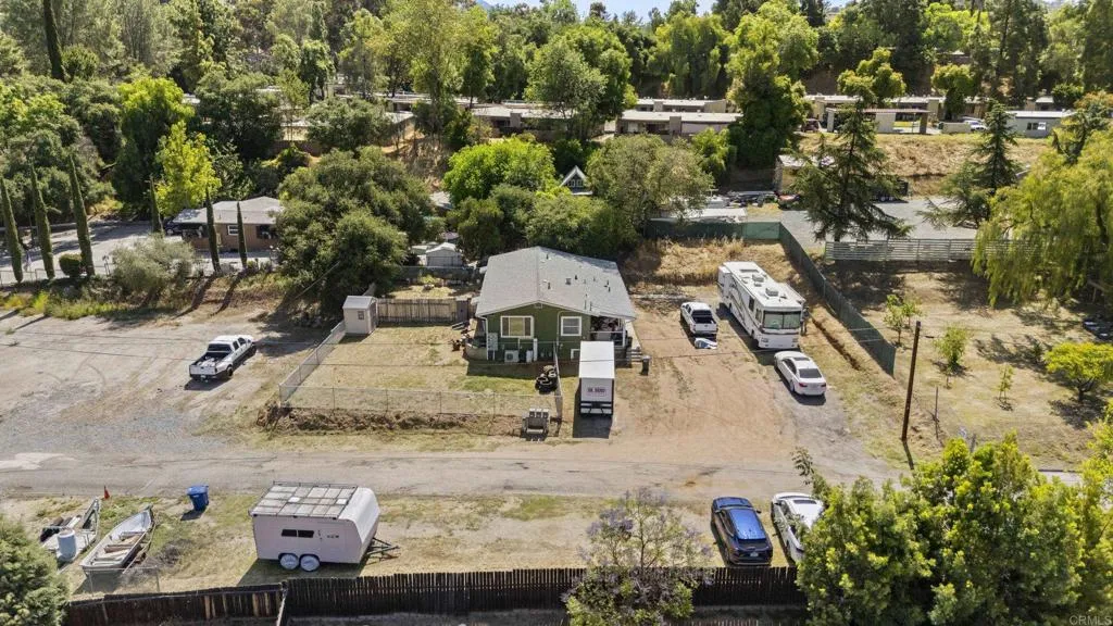 an aerial view of a house with a yard basket ball court