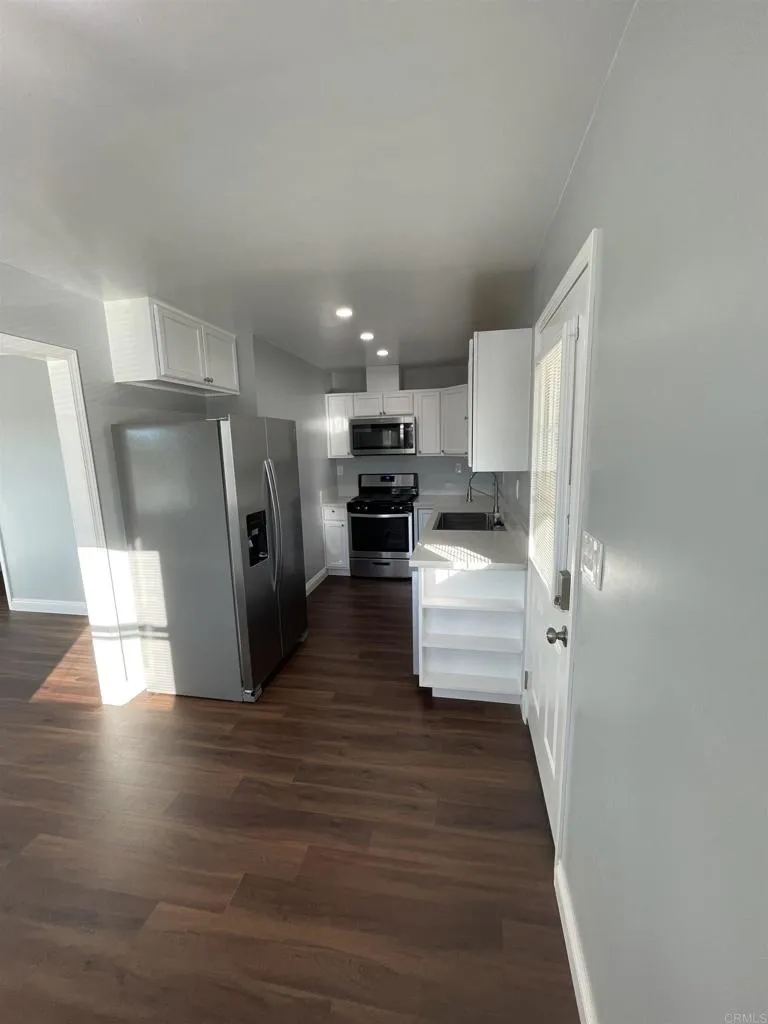 1419 Flo Drive Alpine, CA 91901 - Photo 2 of 27 a view of a kitchen with wooden floor electronic appliances and stairs