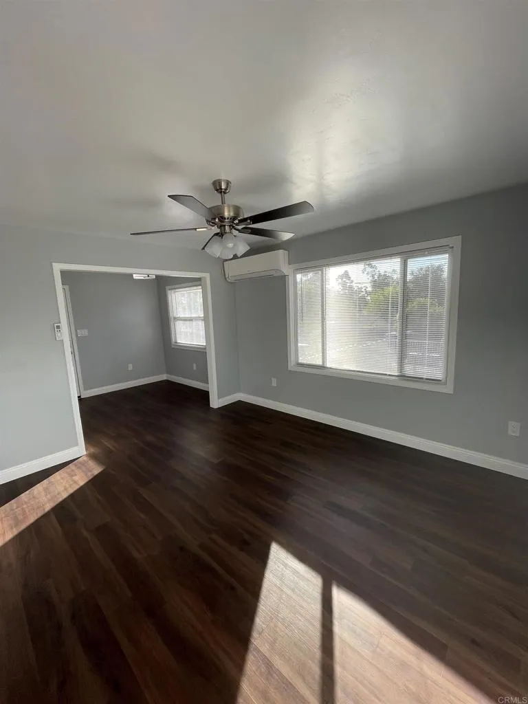 1419 Flo Drive Alpine, CA 91901 - Photo 3 of 27 a view of an empty room with wooden floor and a window