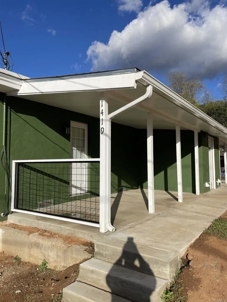 1419 Flo Drive Alpine, CA 91901 - Photo 5 of 27 a view of a house with a floor to ceiling window and potted plants