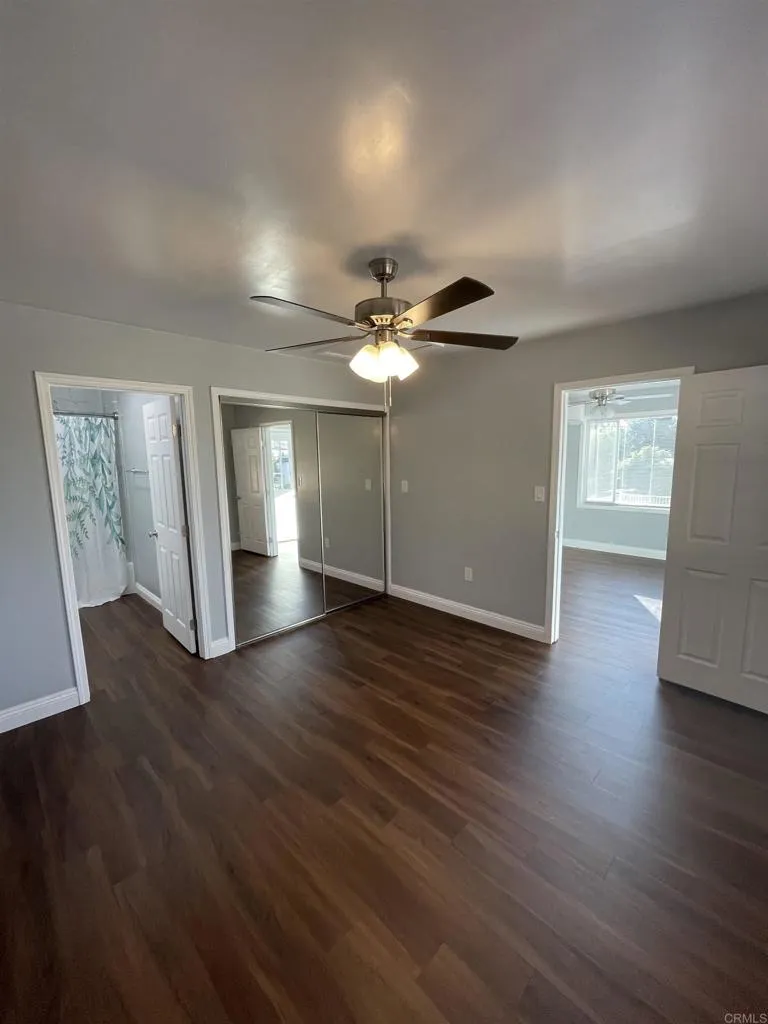 1419 Flo Drive Alpine, CA 91901 - Photo 7 of 27 a view of an empty room with wooden floor and a ceiling fan
