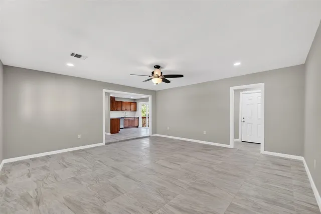 a view of an empty room with window and cabinet