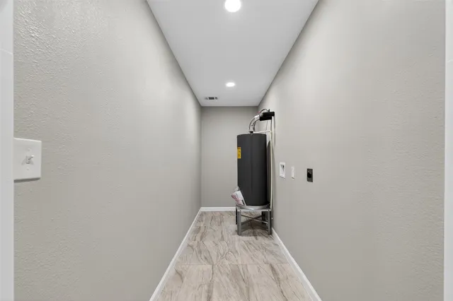a view of a livingroom with wooden floor and a ceiling fan