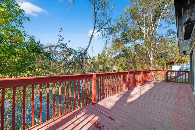 a balcony with wooden floor and fence