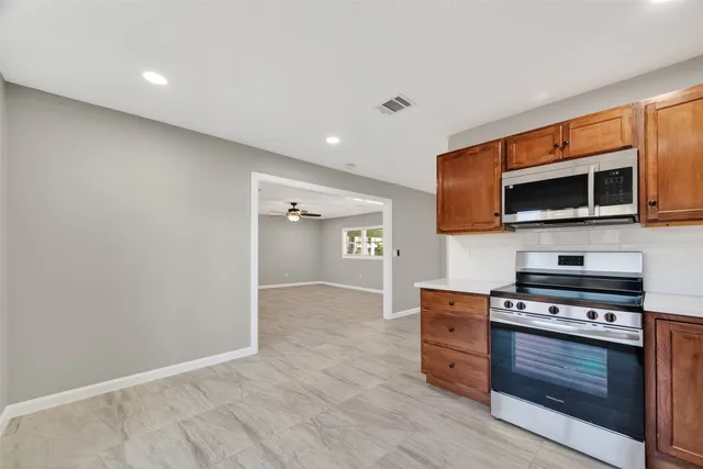 a kitchen with stainless steel appliances a stove and a microwave