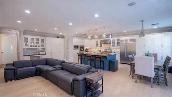 a living room with stainless steel appliances kitchen island granite countertop furniture and a kitchen view