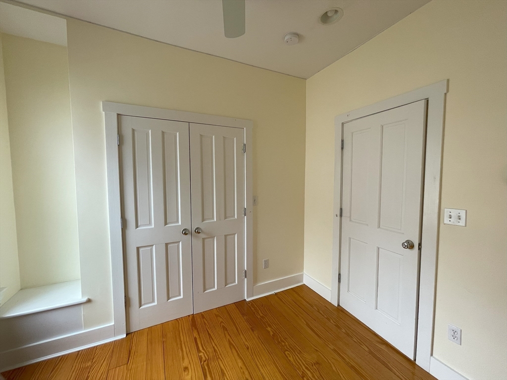 22 Walnut Place, Unit 1 Newton, MA 02460 - Photo 6 of 9 a view of a hallway with wooden floor