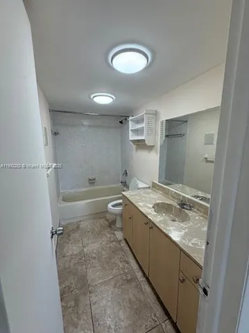a bathroom with a granite countertop sink mirror bathtub and shower