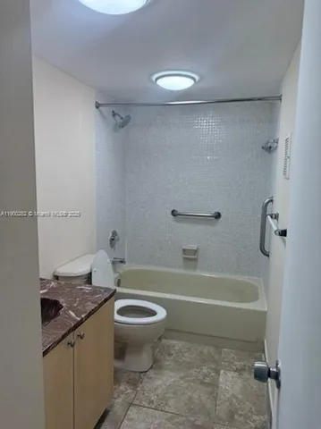 a bathroom with a granite countertop sink a toilet and bathtub