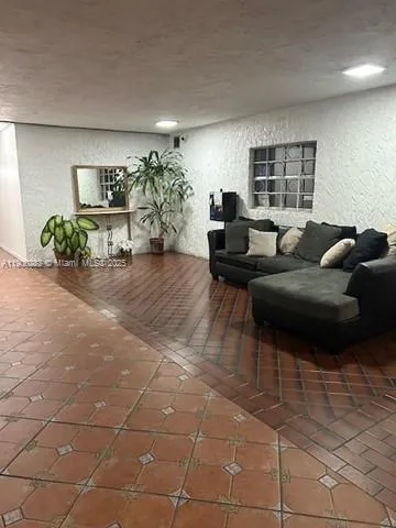 a living room with furniture and flowers