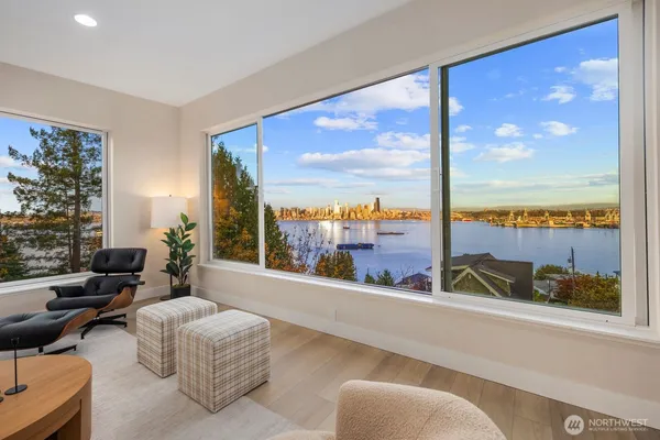 a living room with furniture and floor to ceiling window