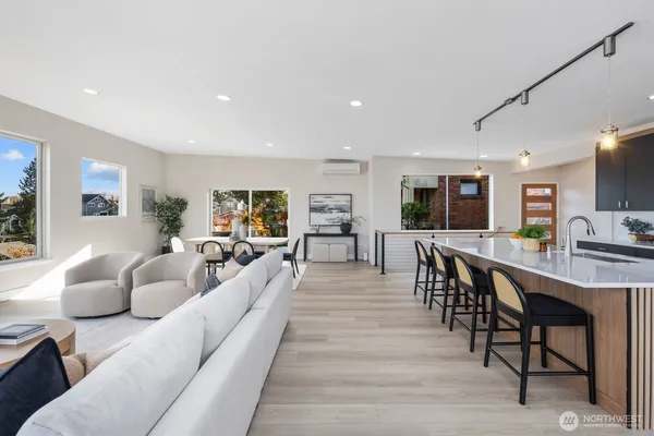 a living room with furniture a wooden floor and a flat screen tv