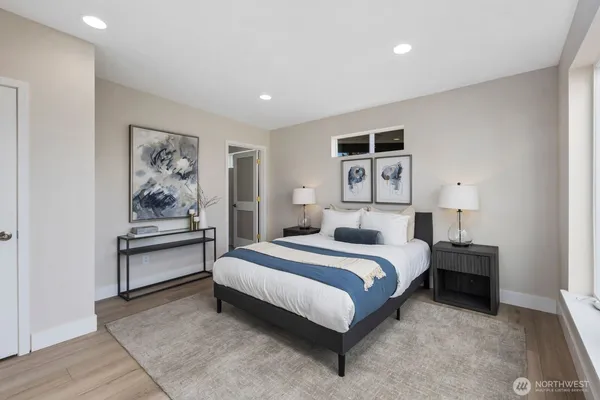 a bedroom with a bed and a painting on the wall