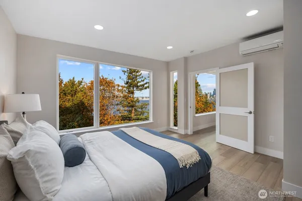 a bedroom with a large bed and a large window